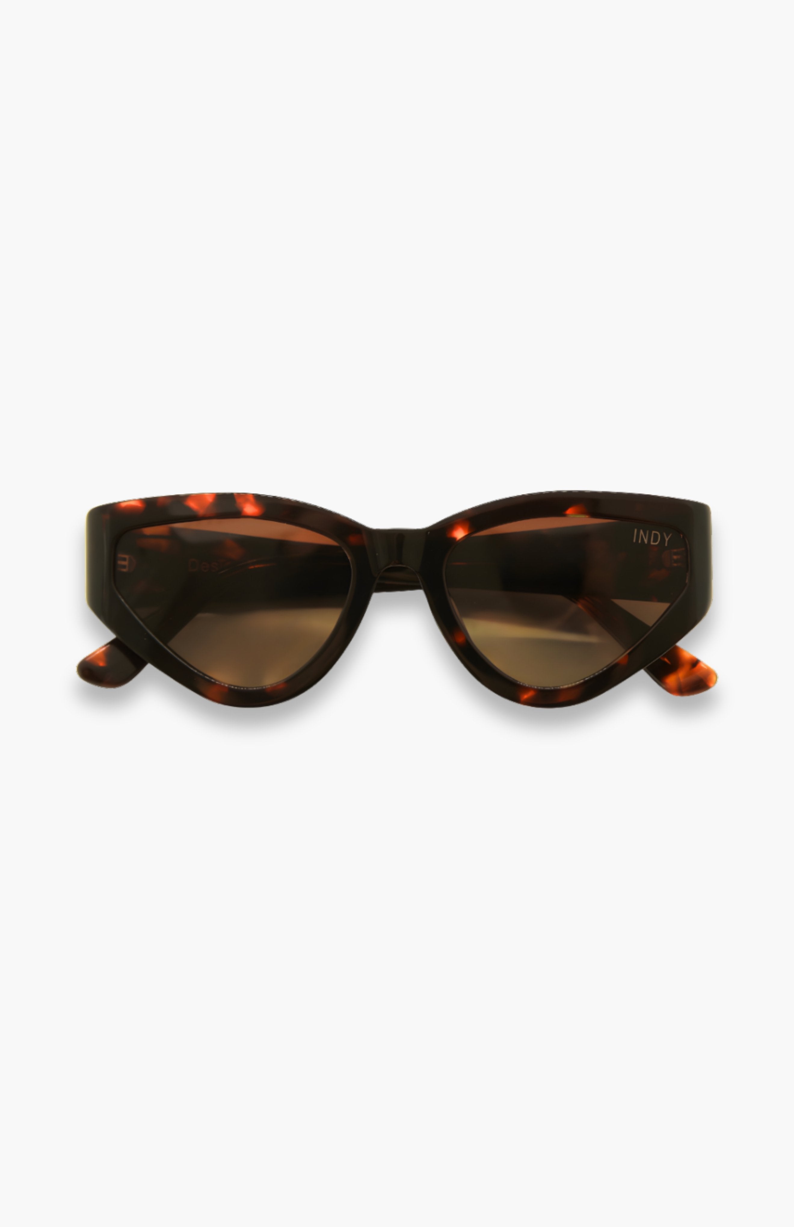 Sunglasses with tortoiseshell frame and dark lenses on a white background