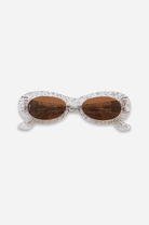 Sunglasses with a glittery frame on a white background