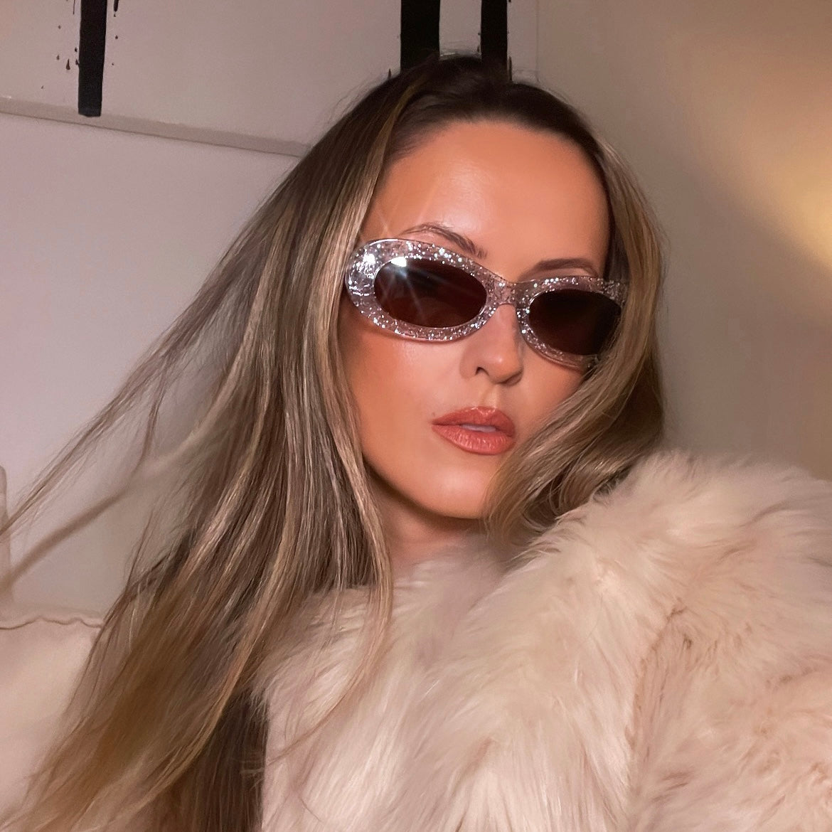 a model wears SoHo Oval Sunglasses In Glitter