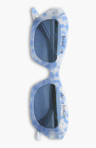 Blue and white sunglasses with a pattern on a white background