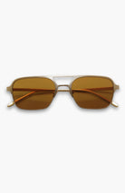 Sunglasses with gold frame and brown lenses on a white background