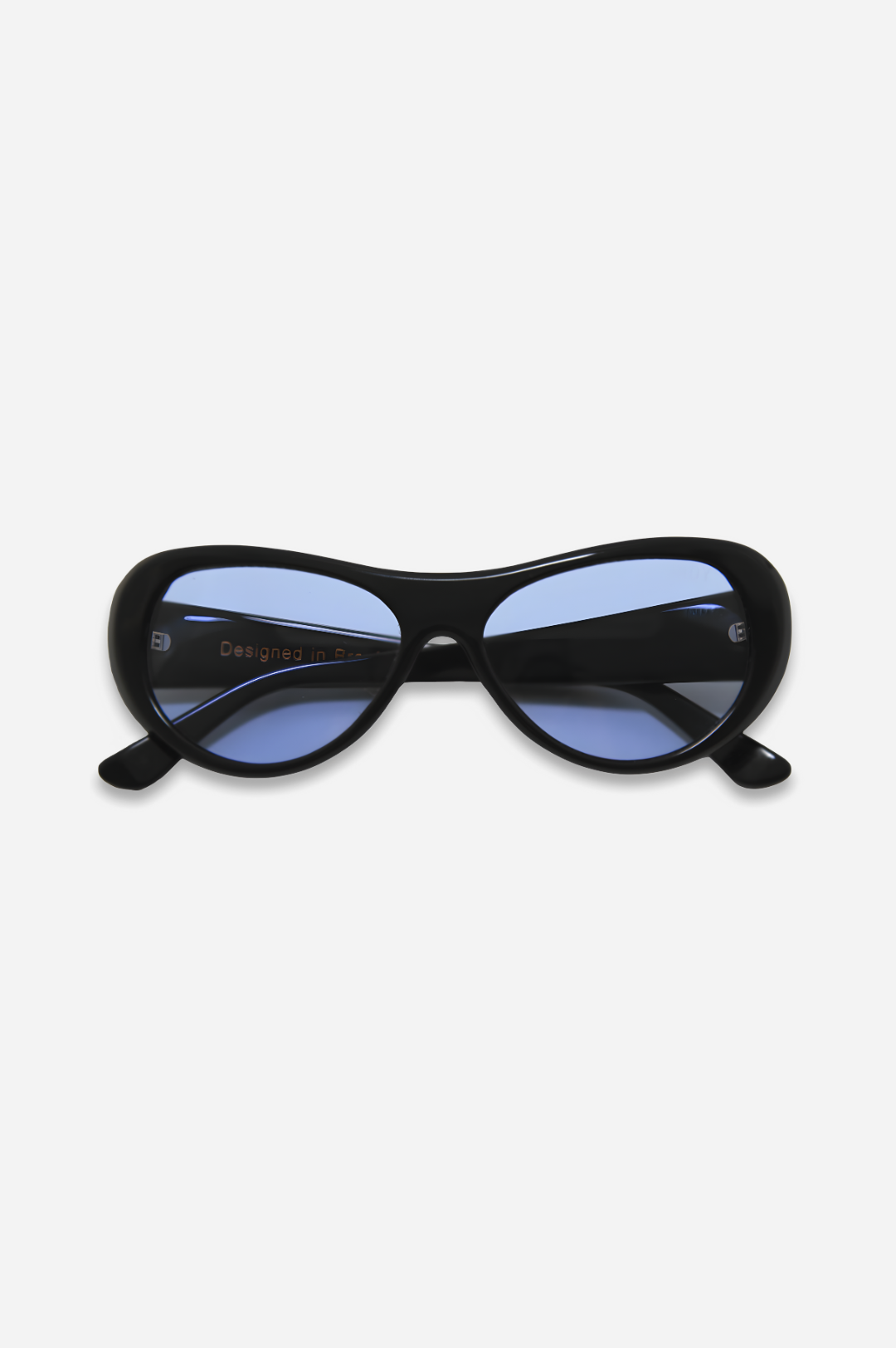 Black cat-eye sunglasses with blue lenses on a white background