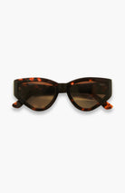 Sunglasses with tortoiseshell frame and dark lenses on a white background